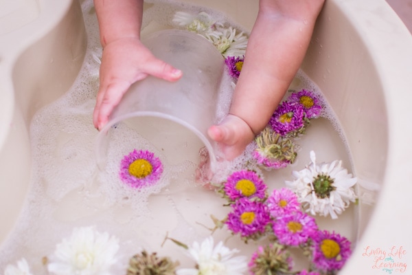 Toddler playing with Flower Sensory Soup.