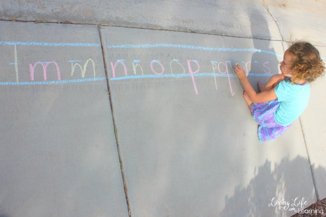 In this post, we will share with you some awesome early writing ideas using sidewalk chalk! My daughter enjoyed not only reviewing her alphabet letter names and sounds, but she also loved practicing writing the letters.