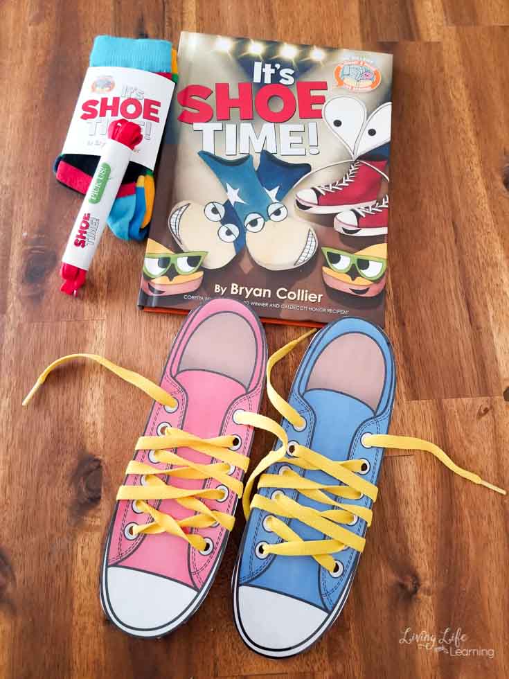 pink and blue Shoe lacing cards with yellow shoe laces on the floor with the It's Shoe Time book.