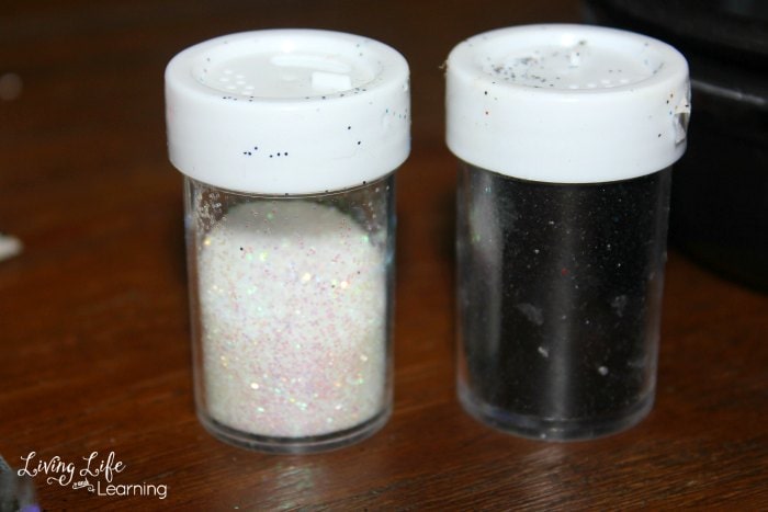Black and white glitter bottles - an optional item to add to penguin painted rocks.