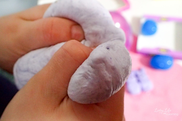 child holding purple peeps slime 