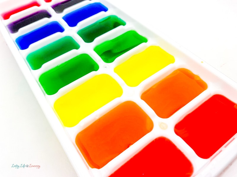 Different colored water in ice cube tray for fun rainbow ice activity 