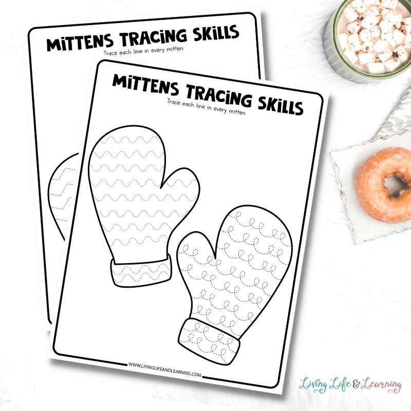 worksheets about tracing mittens placed on a desk next to a cup of hot chocolate and a doughnut