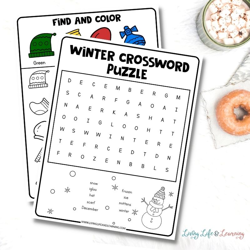 worksheets about winter crossword puzzle and coloring placed on a desk next to a cup of hot chocolate and a doughnut