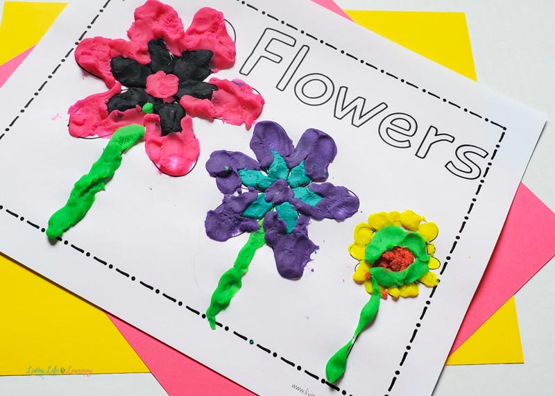 printable spring play dough mat on top of colored papers
