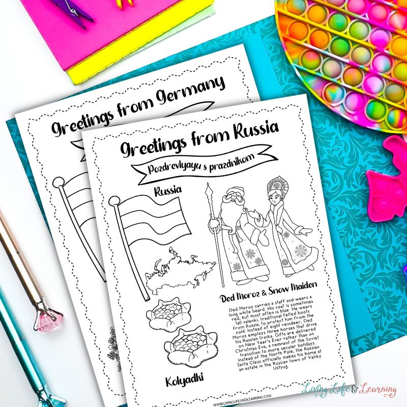 Two pages from Christmas Around the World Coloring Pages are on top of a blue-colored paper surrounded with fidget toys and colored pencils.