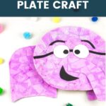 Pink, crepe paper covered paper plate elephant craft on a white backdrop with colorful fuzzy balls surrounding it. On top of the image says Elephant Paper Plate Craft in white bold text on top of a translucent dark blue rectangle.