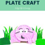 Pink elephant in front of DIY grass and bushes. On top is written Elephant Paper Plate Craft on top of a green rectangle.