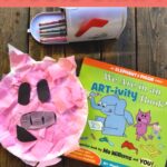 Piggie Paper Plate Craft: A pink Piggie paper plate craft beside an Elephant and Piggie book.