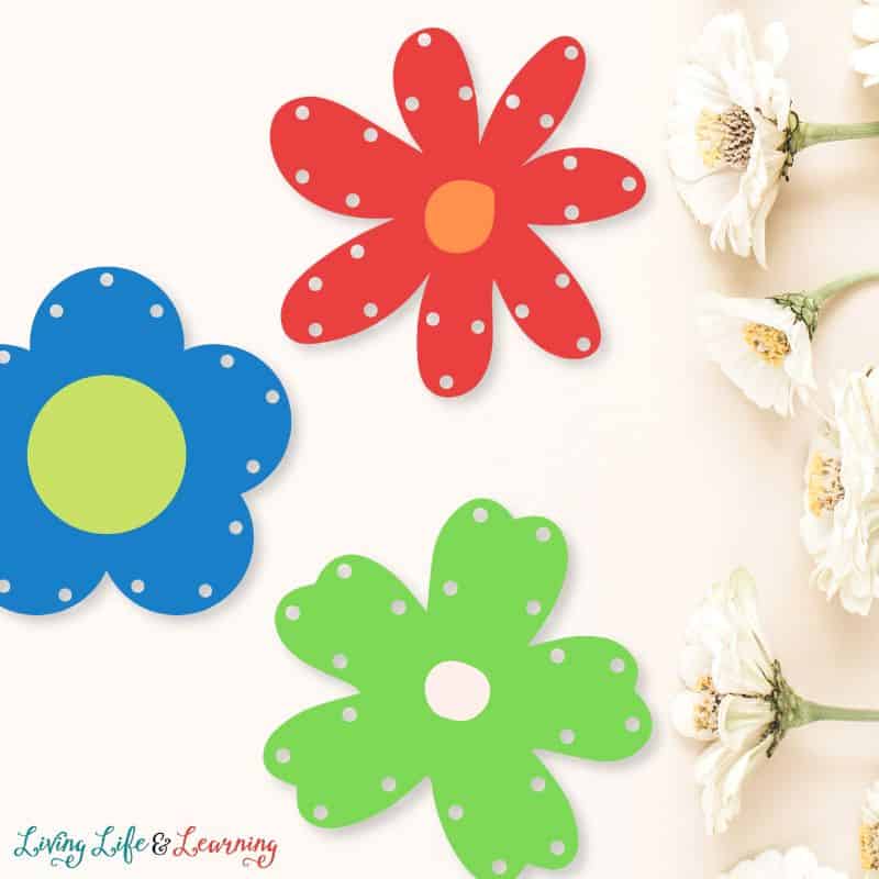 Three Printable Flower Lacing Cards on a table