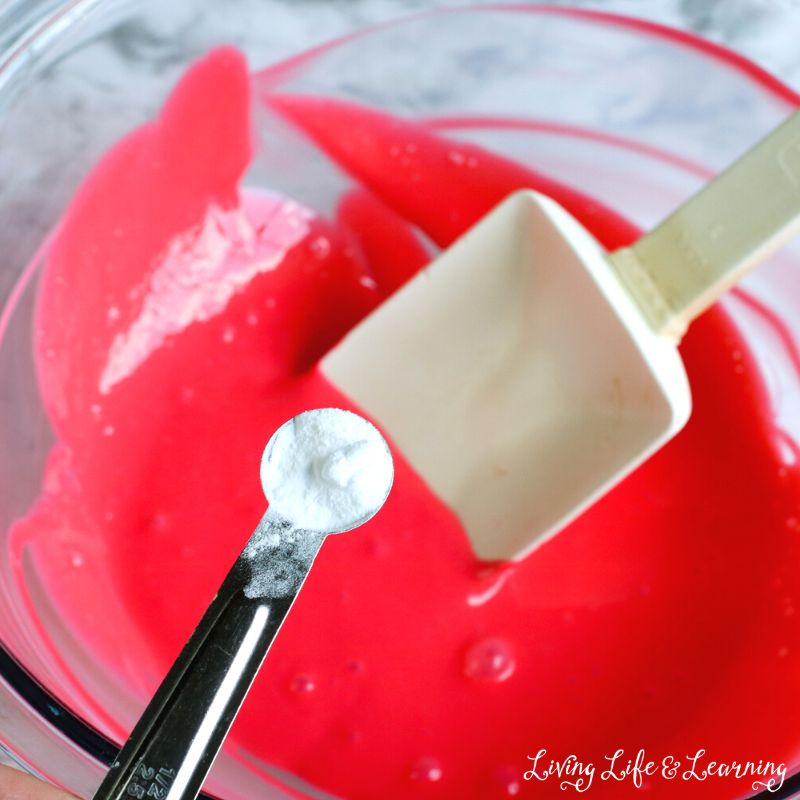 A scoop of baking soda will be added to the mixture of water, food coloring, apple scent, and glue.