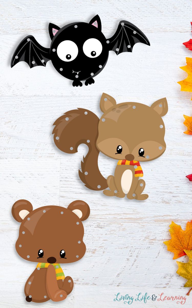 Three Fall Animals Lacing Cards on a table