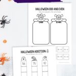 Two Halloween Addition Worksheets on a table