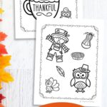 Two Thanksgiving Coloring Pages on a table