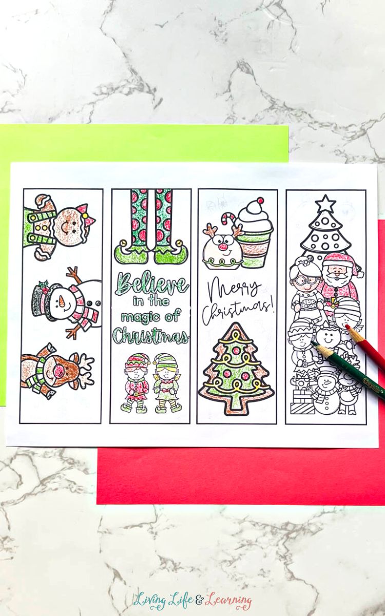 Four uncut Printable Christmas Bookmarks on a table
