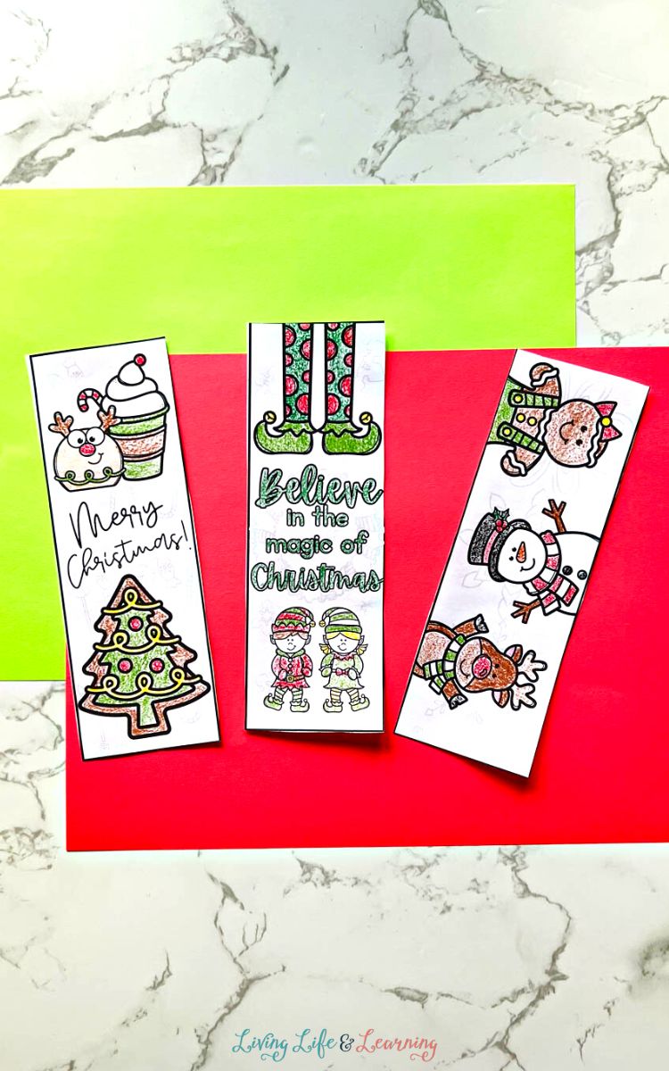 Three Printable Christmas Bookmarks on a table
