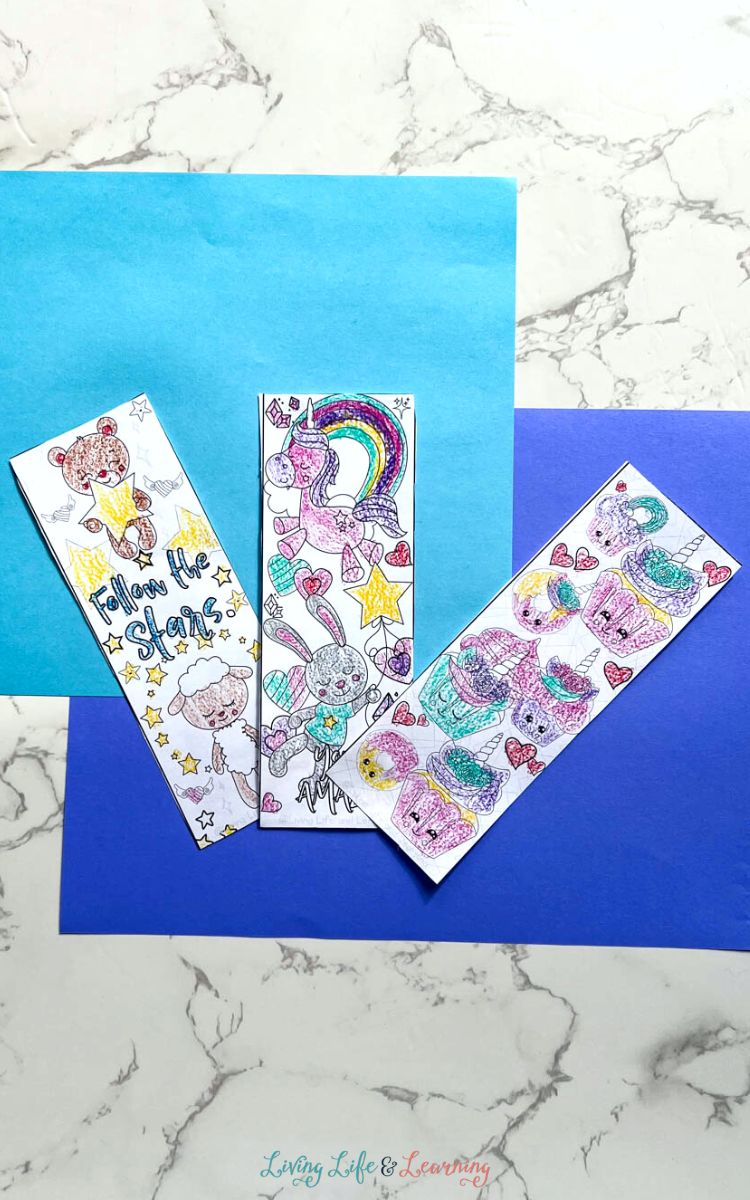 Three Printable Unicorn Bookmarks on a table