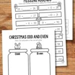 Three Christmas Addition Worksheets on a table