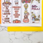 Four uncut Printable Fall Bookmarks on a table