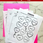 Three Valentine’s Day Worksheets on a table