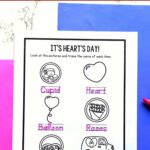 Two Valentine Handwriting Worksheets on a table