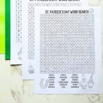 Three St. Patrick’s Day Word Search printables on a table