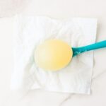 Rubber Egg Experiment photo showing an egg on a spoon
